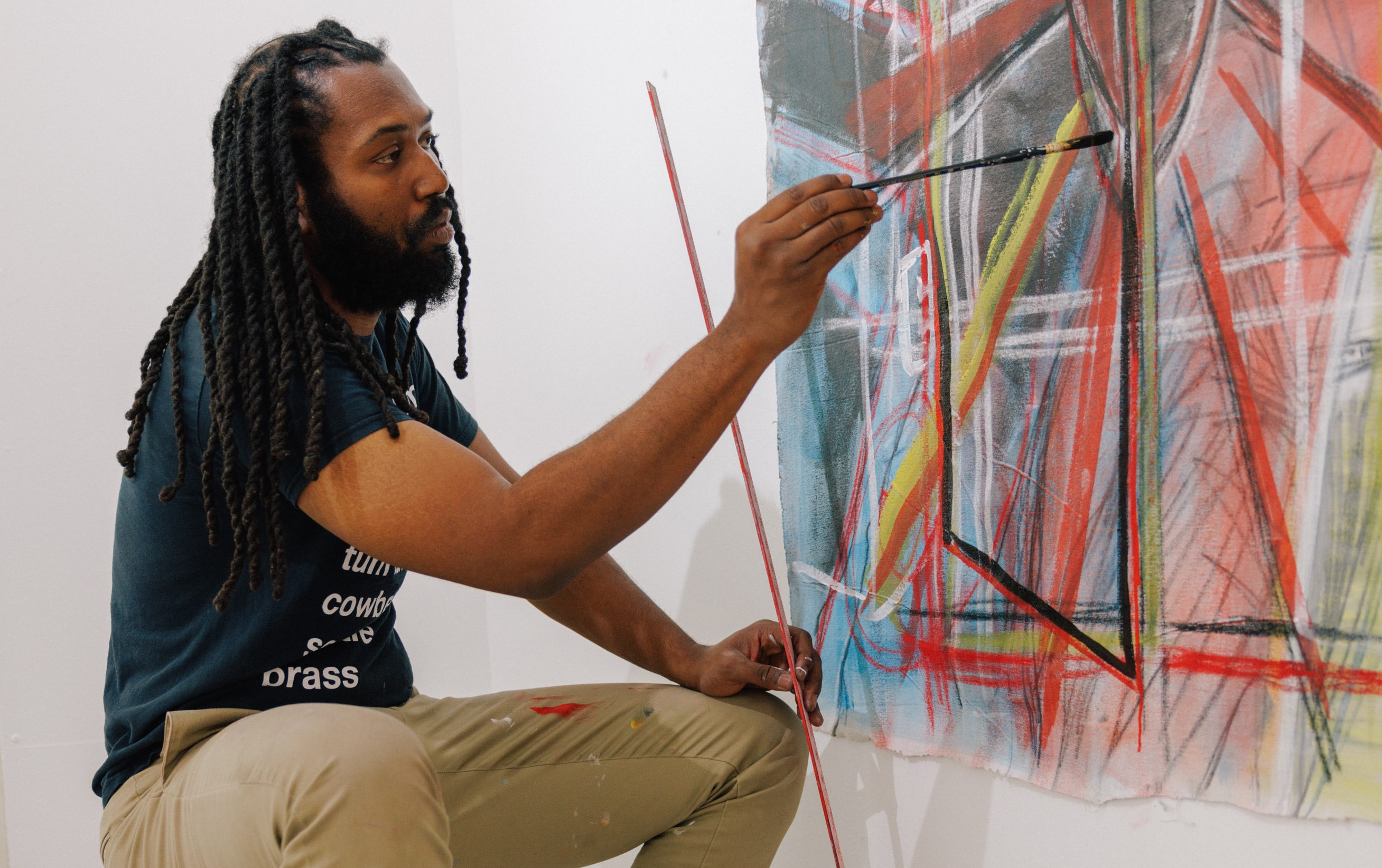 an artist paints a canvas