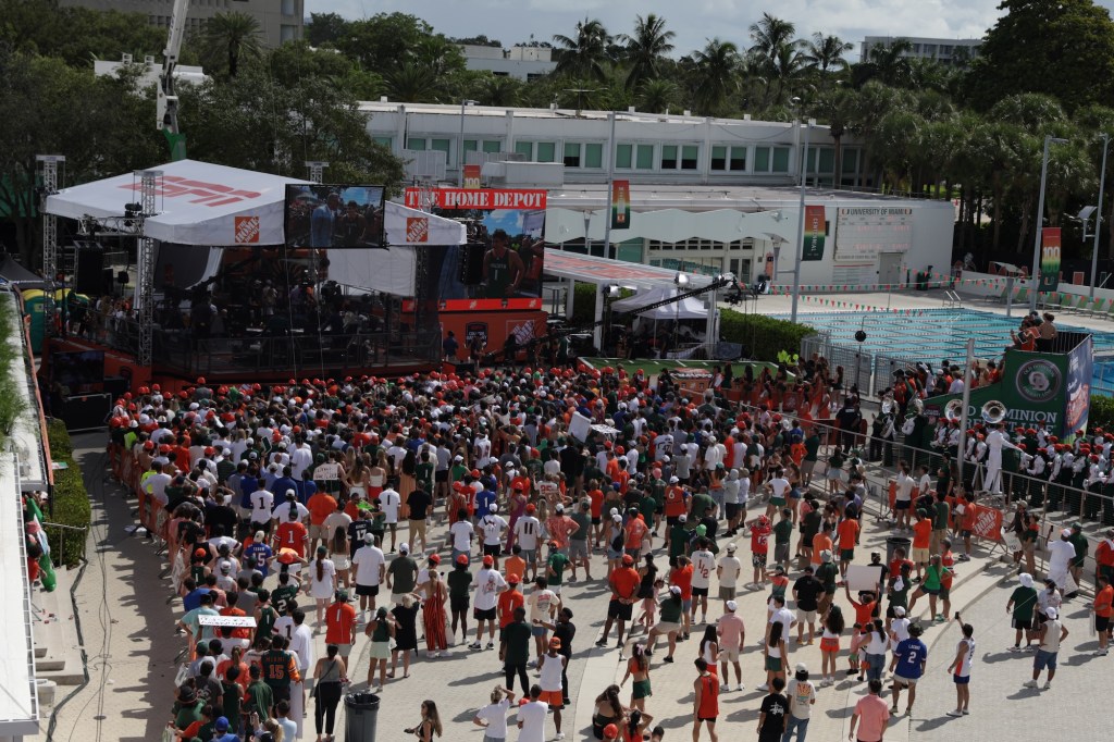 overhead view of a college football tailgate near a stage and next to a pool
