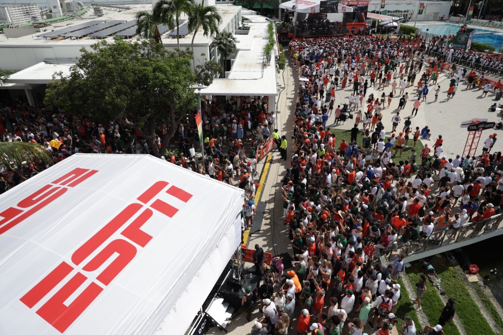 an outdoor tailgate party with a tent reading ESPN