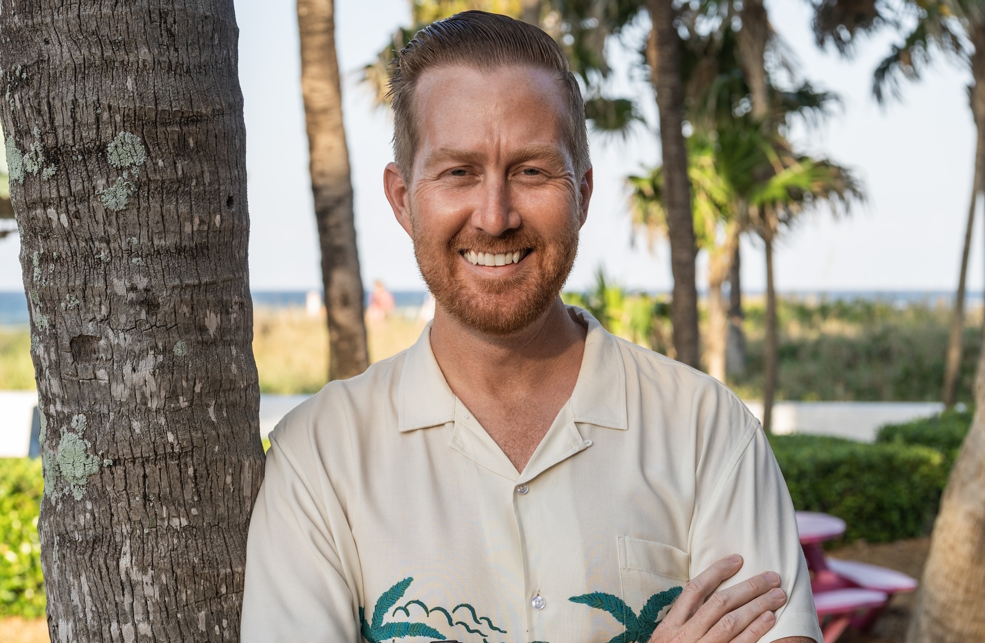 photo of a man standing among palm trees in South Florida