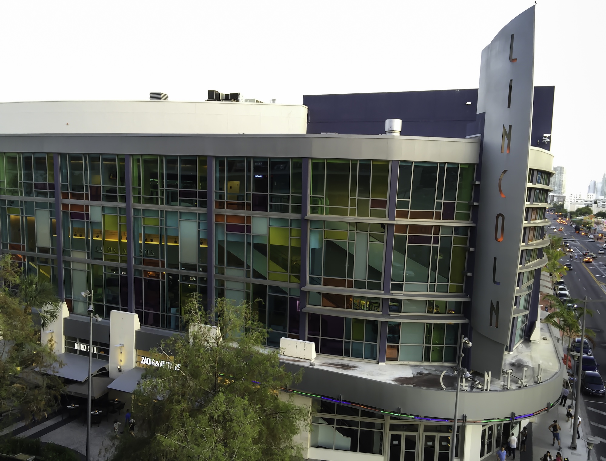 aerial view of a movie theater with multicolored windows and a sign reading "Lincoln"