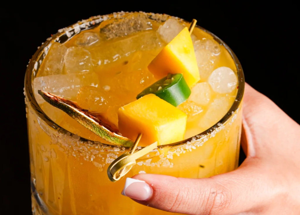 a yellow drink and a hand