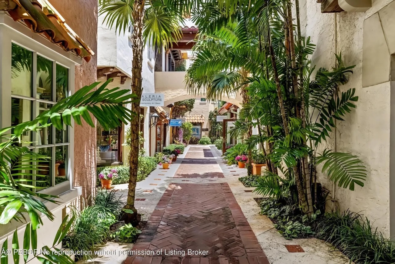 Depicted is a brick path leading through the block beneath the penthouse tower.