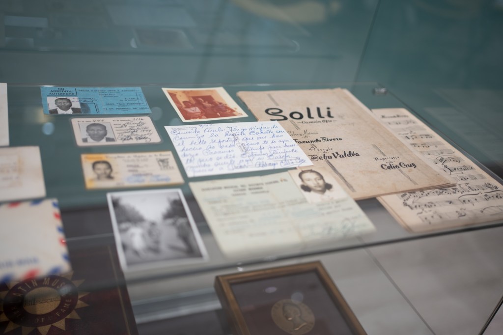 old ID cards, letters, and sheet music on display as part of an exhibition