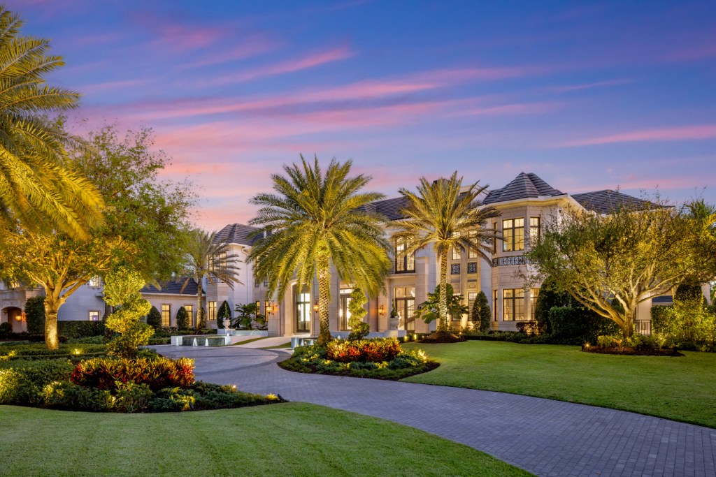 View of the driveway and front of the house at night