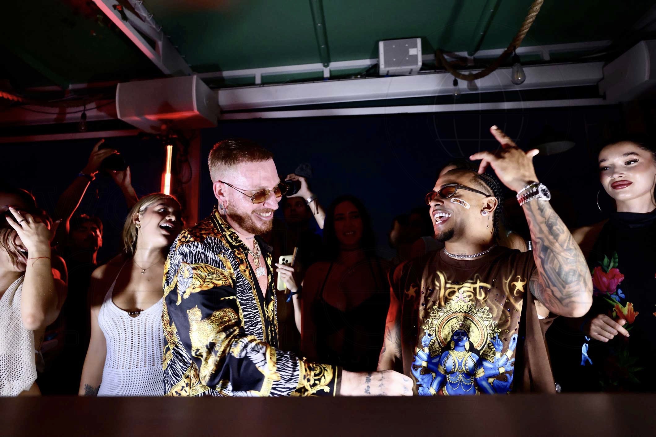 French DJ Hugel behind a DJ booth with Puerto Rican singer Ozuna