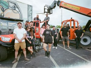 A group of people working on setting up a festival.