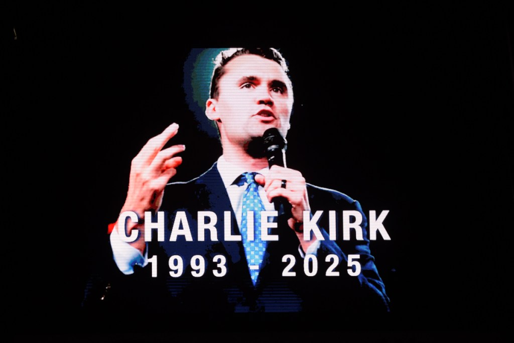 A video of Charlie Kirk on a big screen.