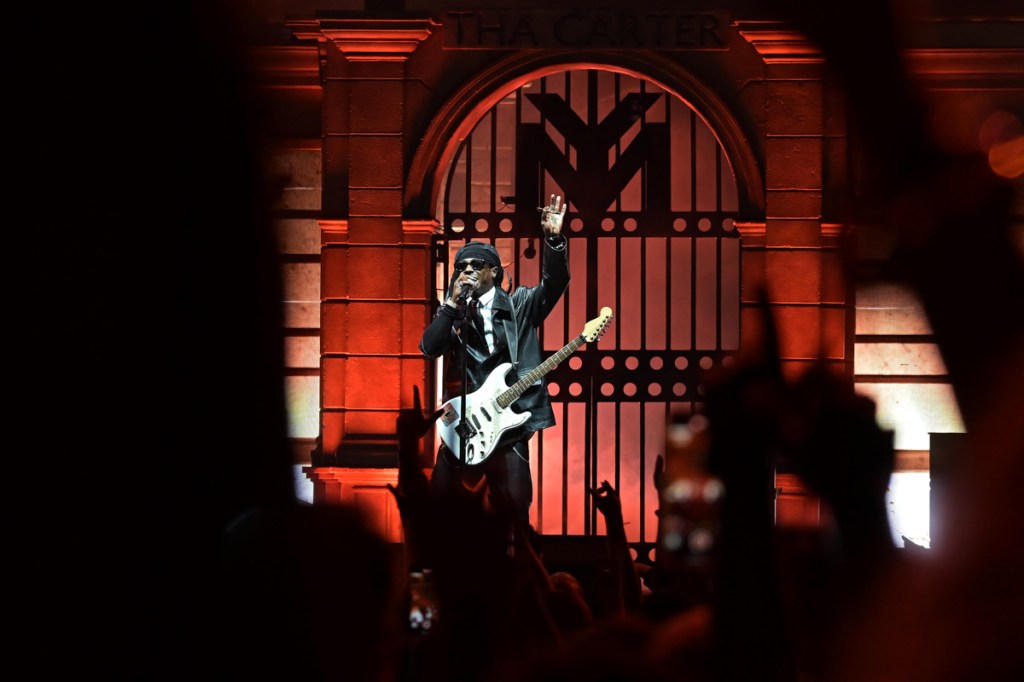 Lil Wayne performing on stage. 