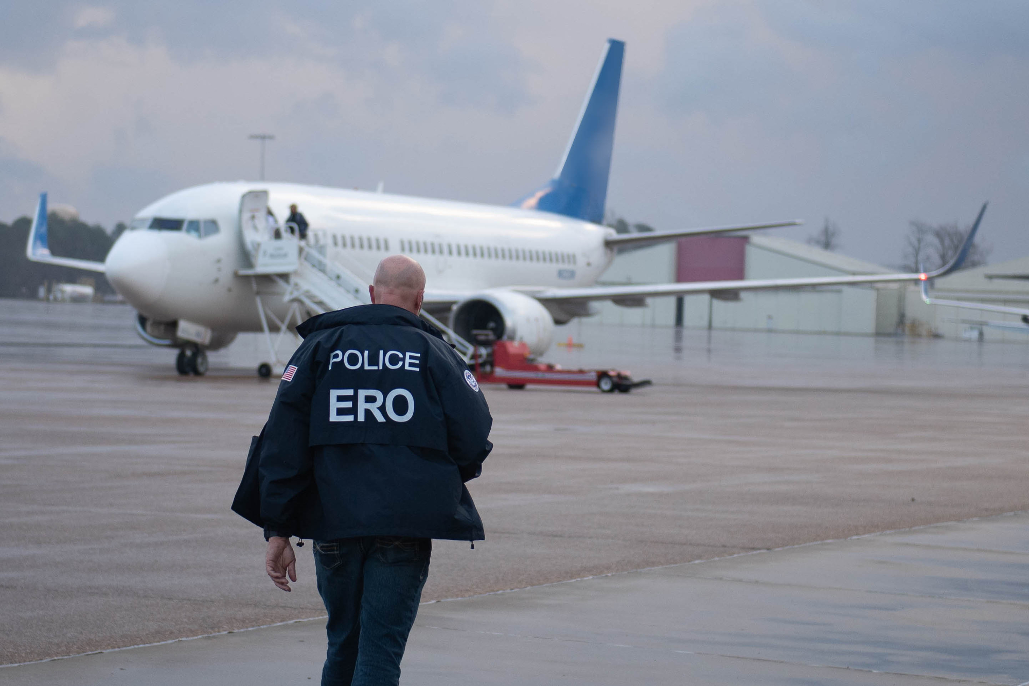 An Enforcement and Removal Operations (ERO) deportation officer brings paperwork to the charter flight to Guatemala.