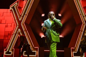 Picture of T-pain singing on stage.