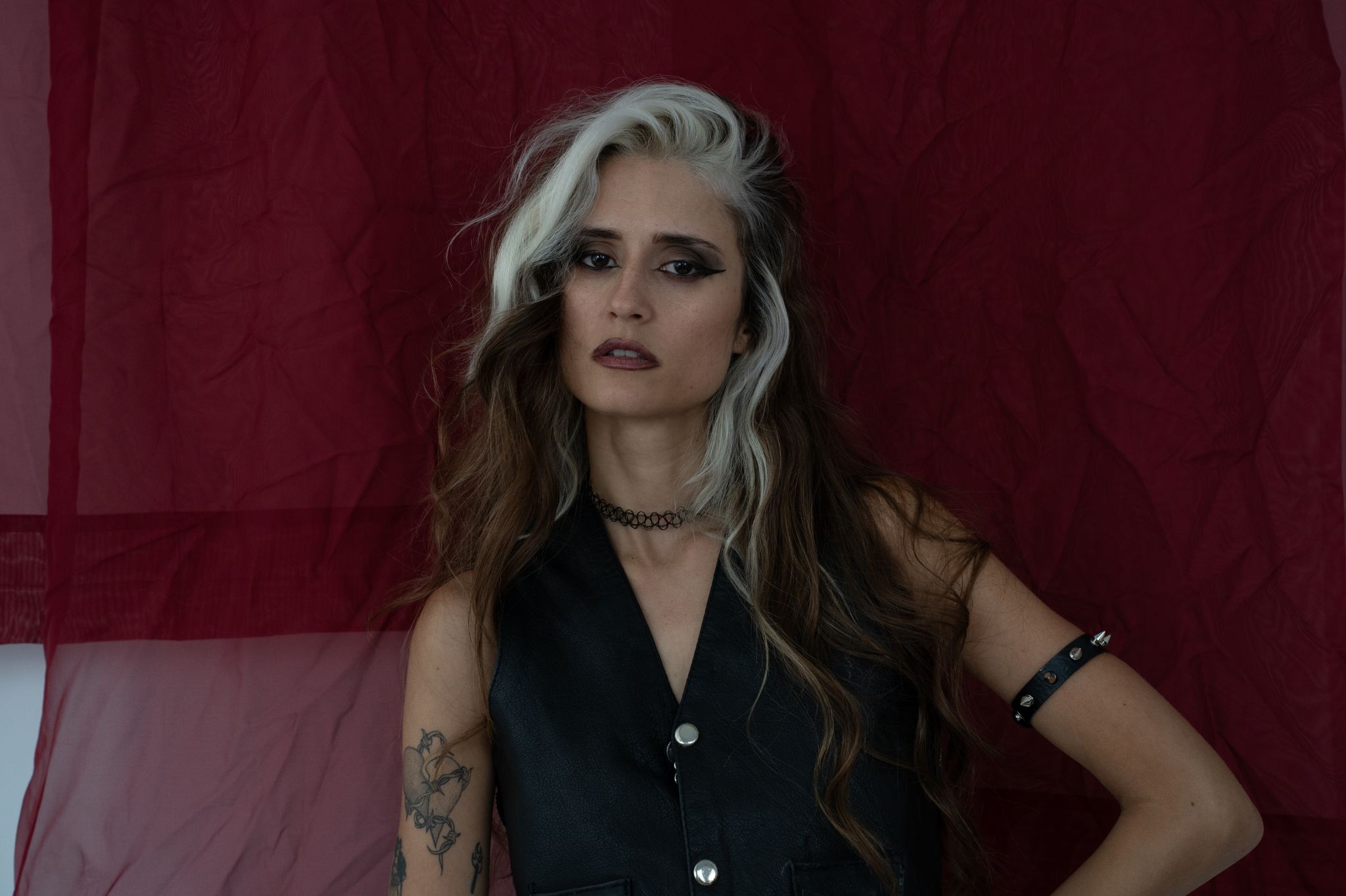 Photo of a woman with brown and white hair looking at the camera.