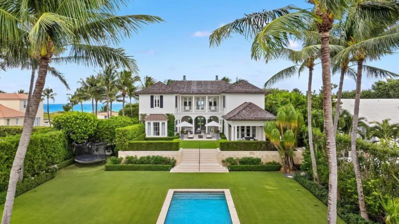 an aerial view of the mansion's backyard and pool