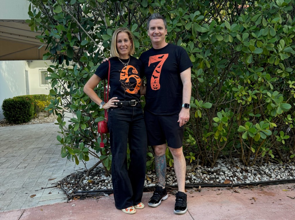 photo of a woman in a t-shirt with a number six posing next to a man in a t-shirt with a number seven on it