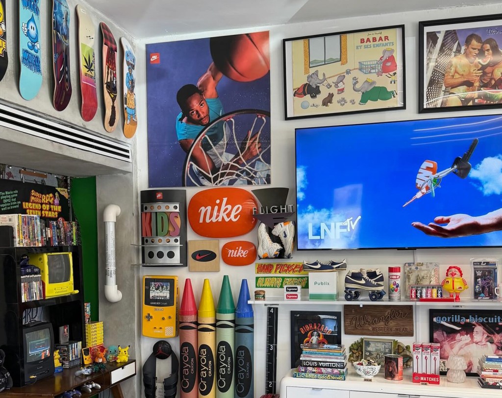 photo of the interior of a vintage shop with toys on shelves and framed posters on the walls
