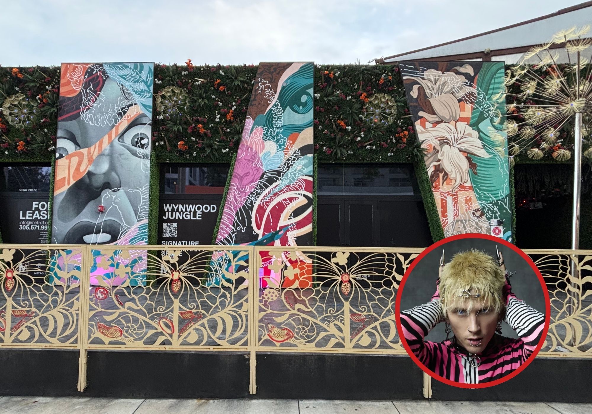 The front of a building covered in graffiti and a portrait of MGK
