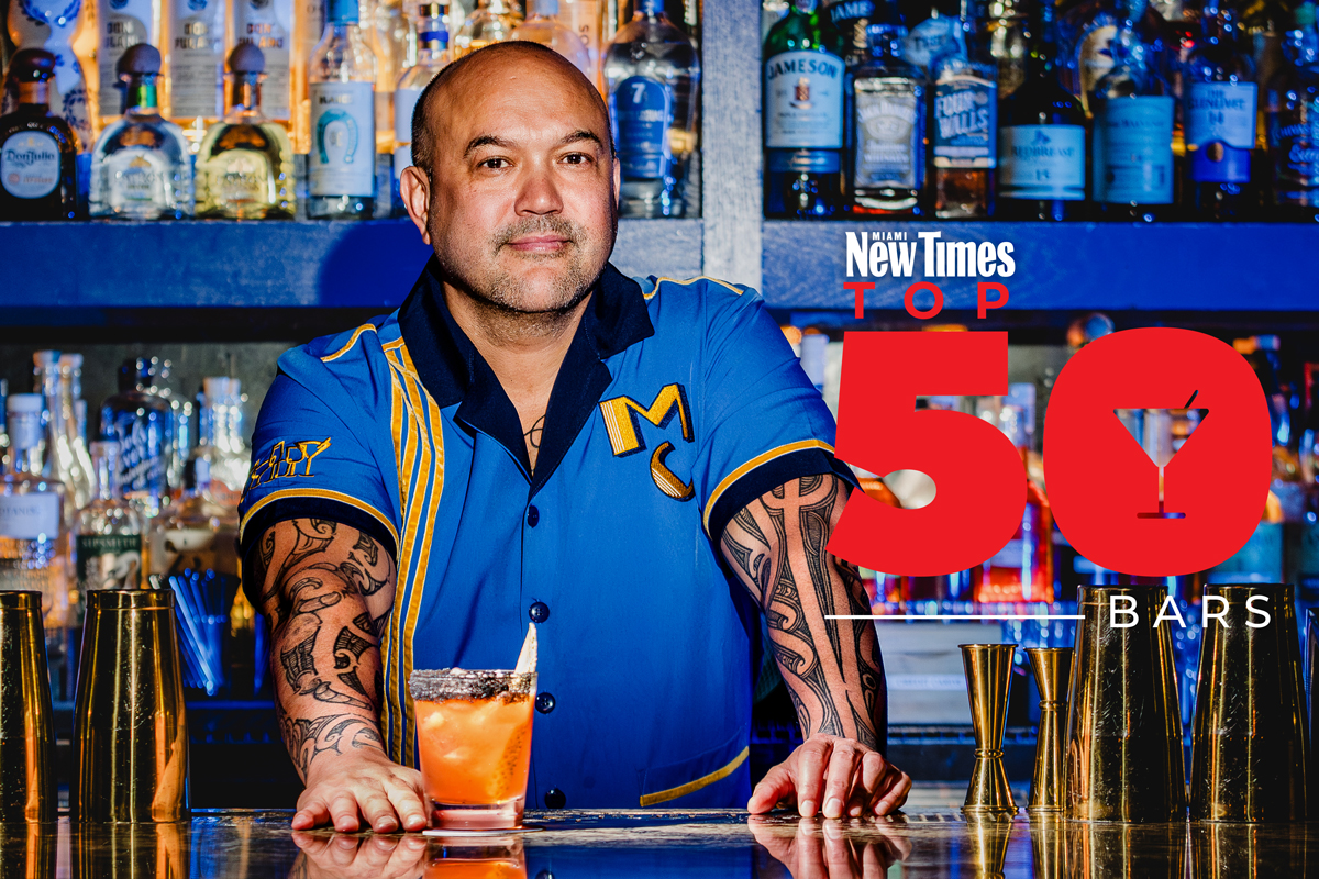 a man posing with a cocktail