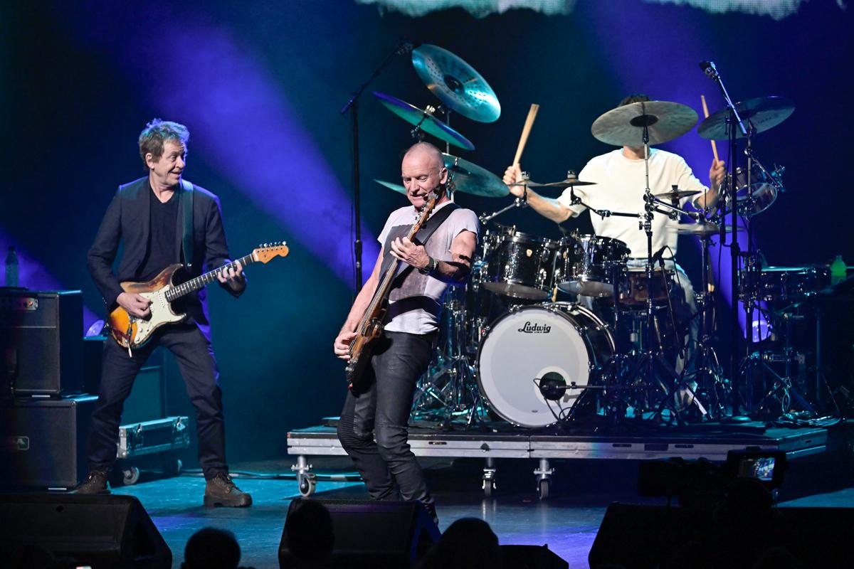 Photo of a rock band performing on stage.