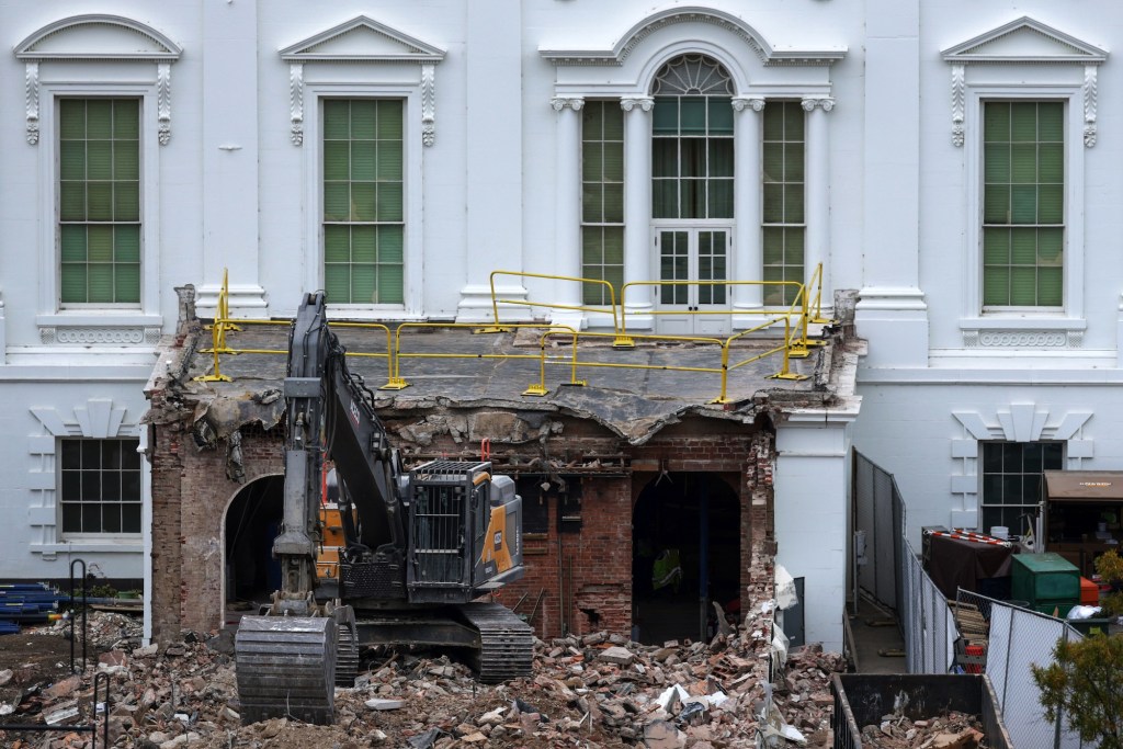 An excavator sits on the rubble after the East Wing of the White House was demolished on October 28, 2025, in Washington, D.C. The demolition is part of Donald Trump's plan to build a ballroom on the eastern side of the White House.