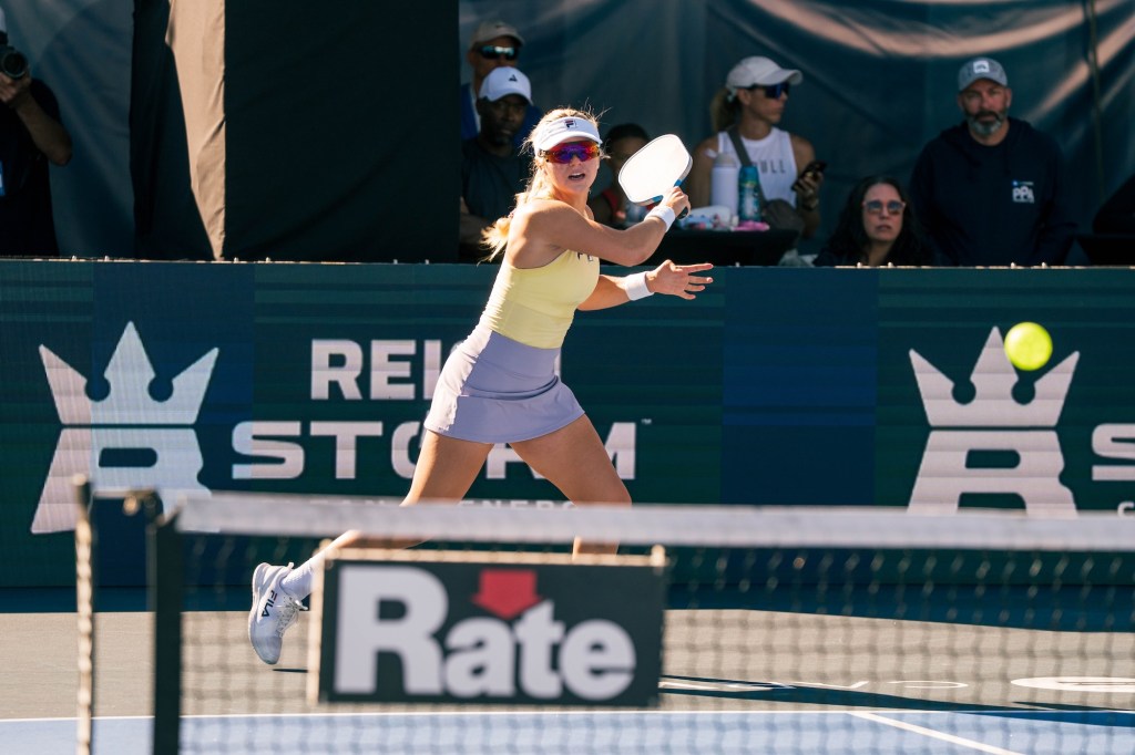 photo of a female pickleball player playing on a court