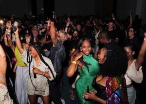 photo of people partying and posing for the camera on a dance floor