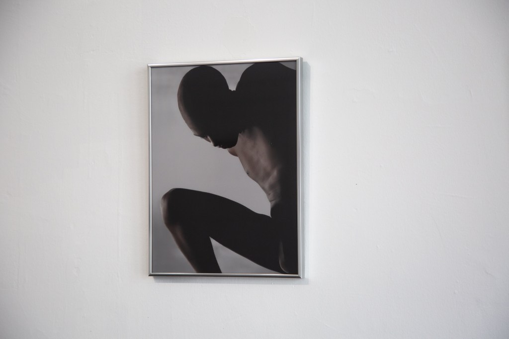 photo of a framed image of a person in shadow on a gallery wall