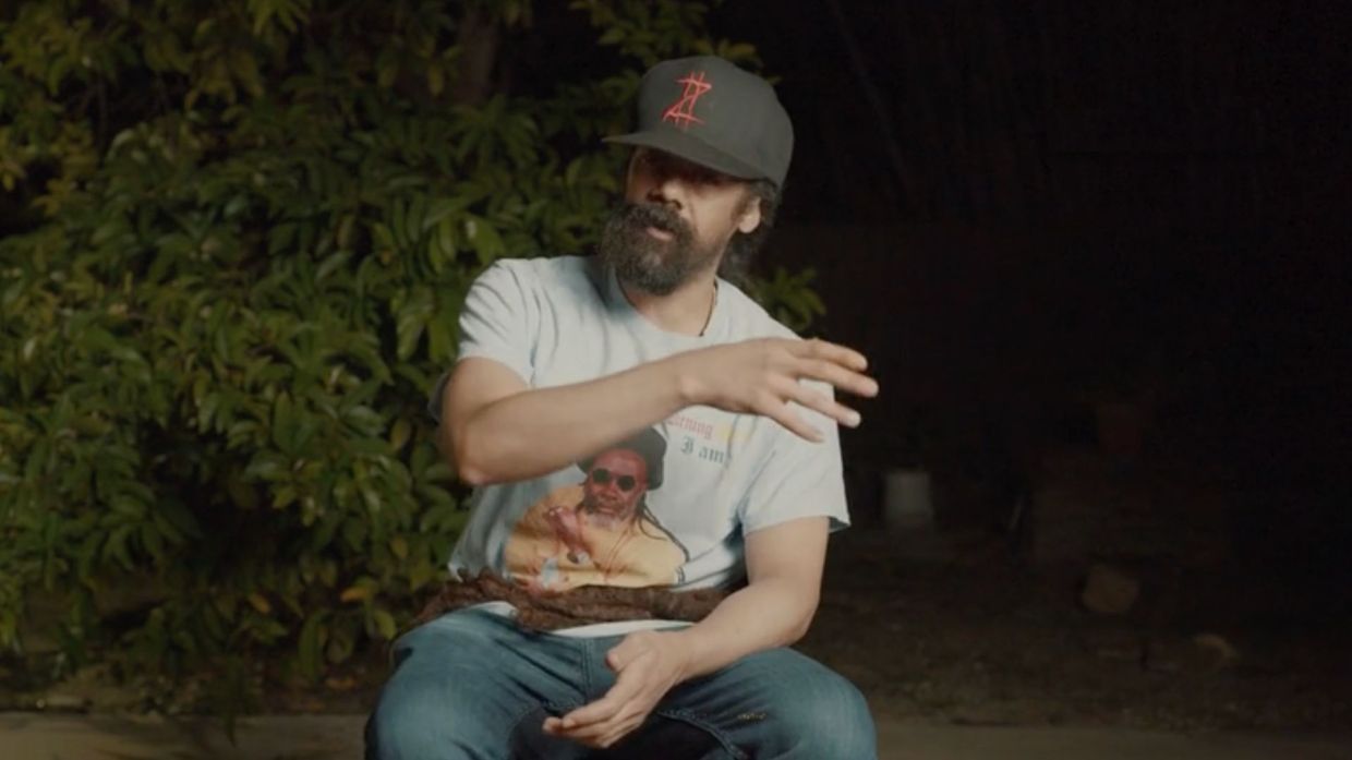 Photo of a man talking sitting on a chair