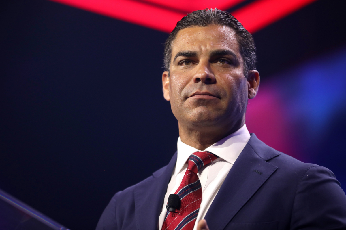 Miami Mayor Francis Suarez wearing a black suit with a white shirt and red tie