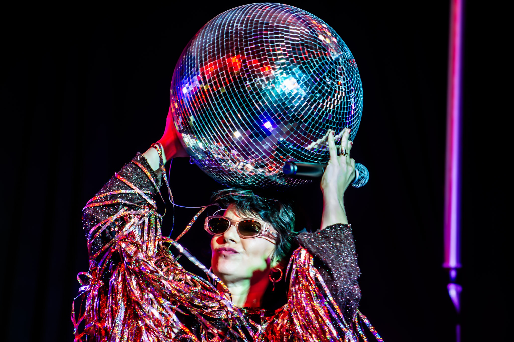 Photo of a woman holding a disco ball