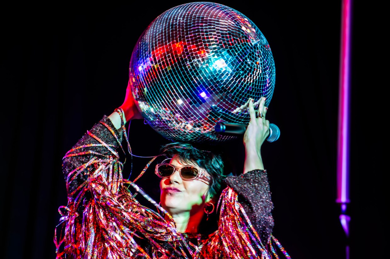 Photo of a woman holding a disco ball