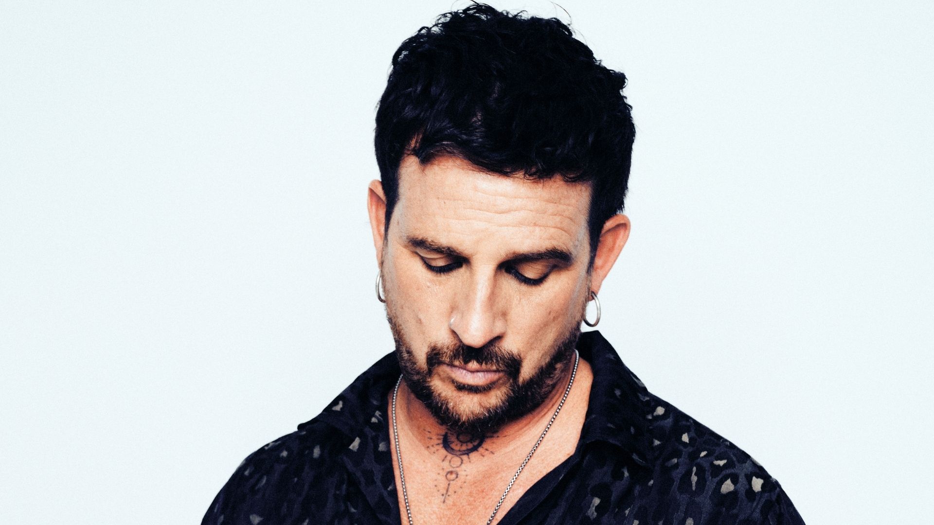 Photo of a man looking down.