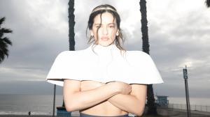 Photo of a woman wearing a white top .