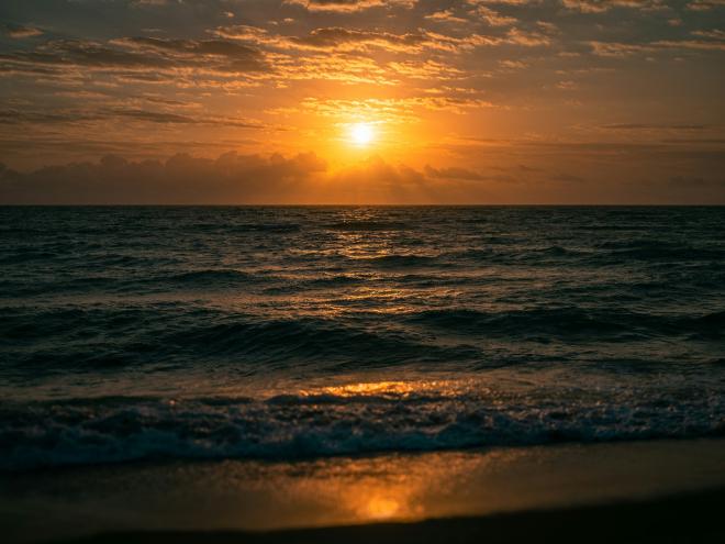 photo of the sun setting over the ocean in Miami