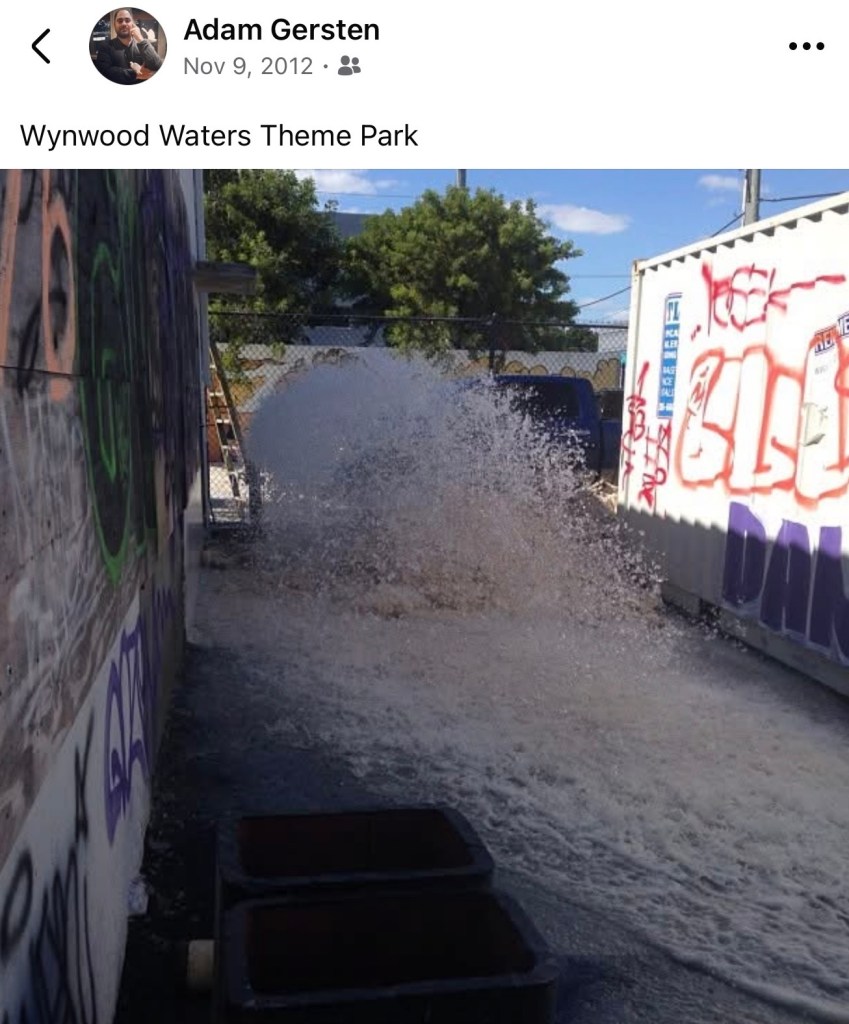 screenshot of a Facebook post showing water bursting from a broken pipe with the caption, "Wynwood Waters Theme Park"