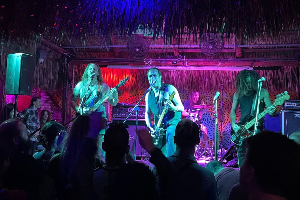 A rock band with guitars on stage in Miami