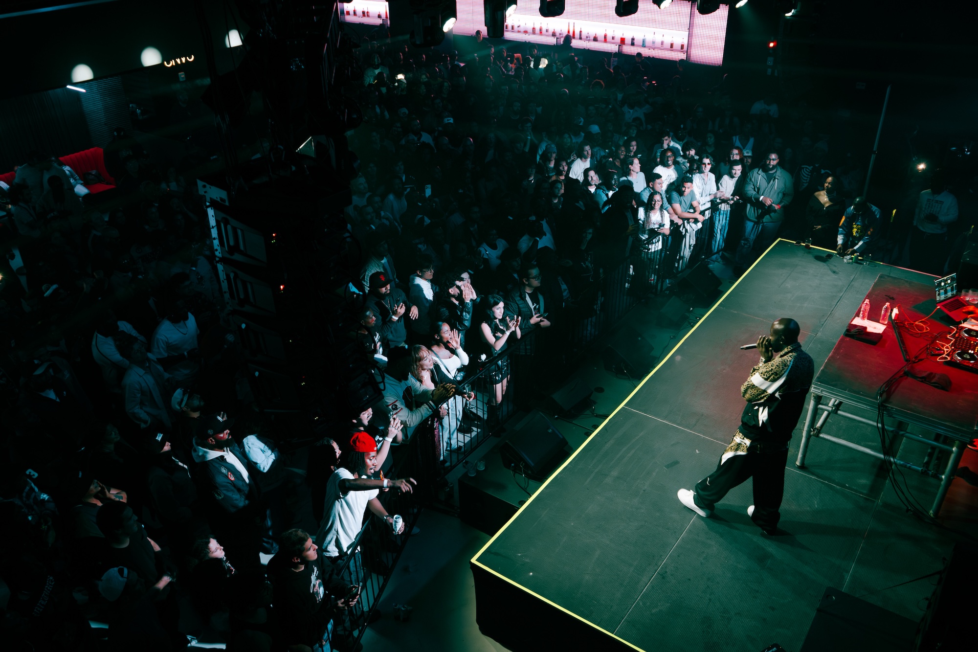 A man singing on stage in front of a crowd.