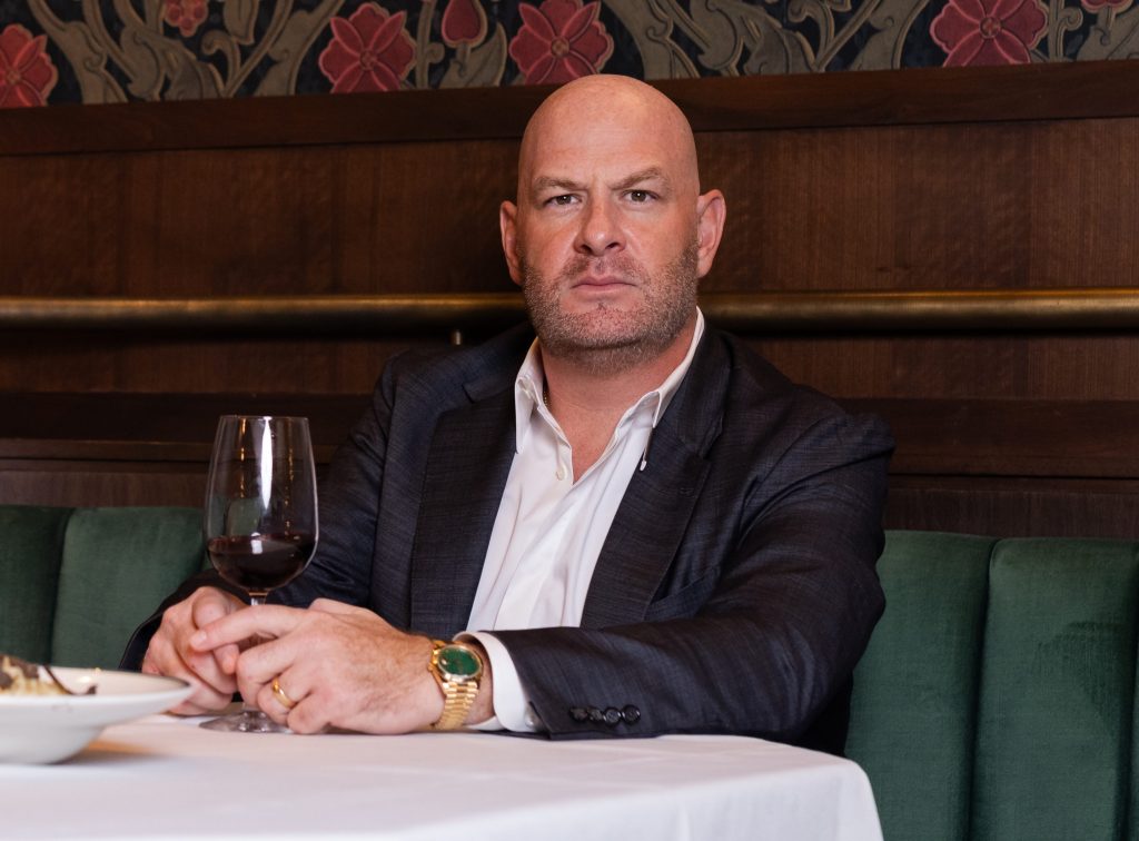 a man posing at a dining table