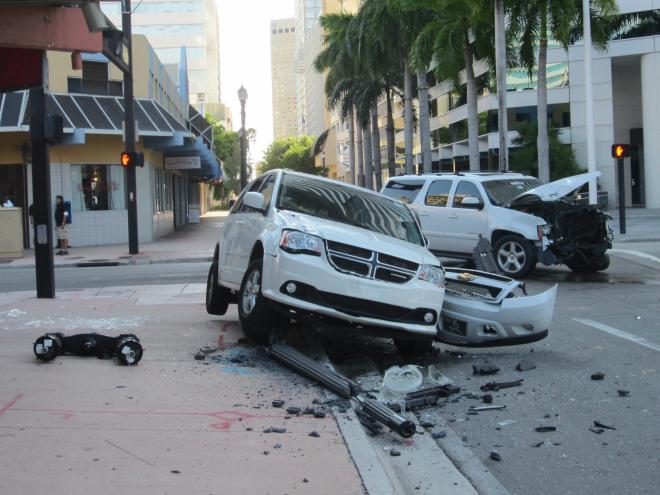 a damaged white van and white SUV in the aftermath of a crash