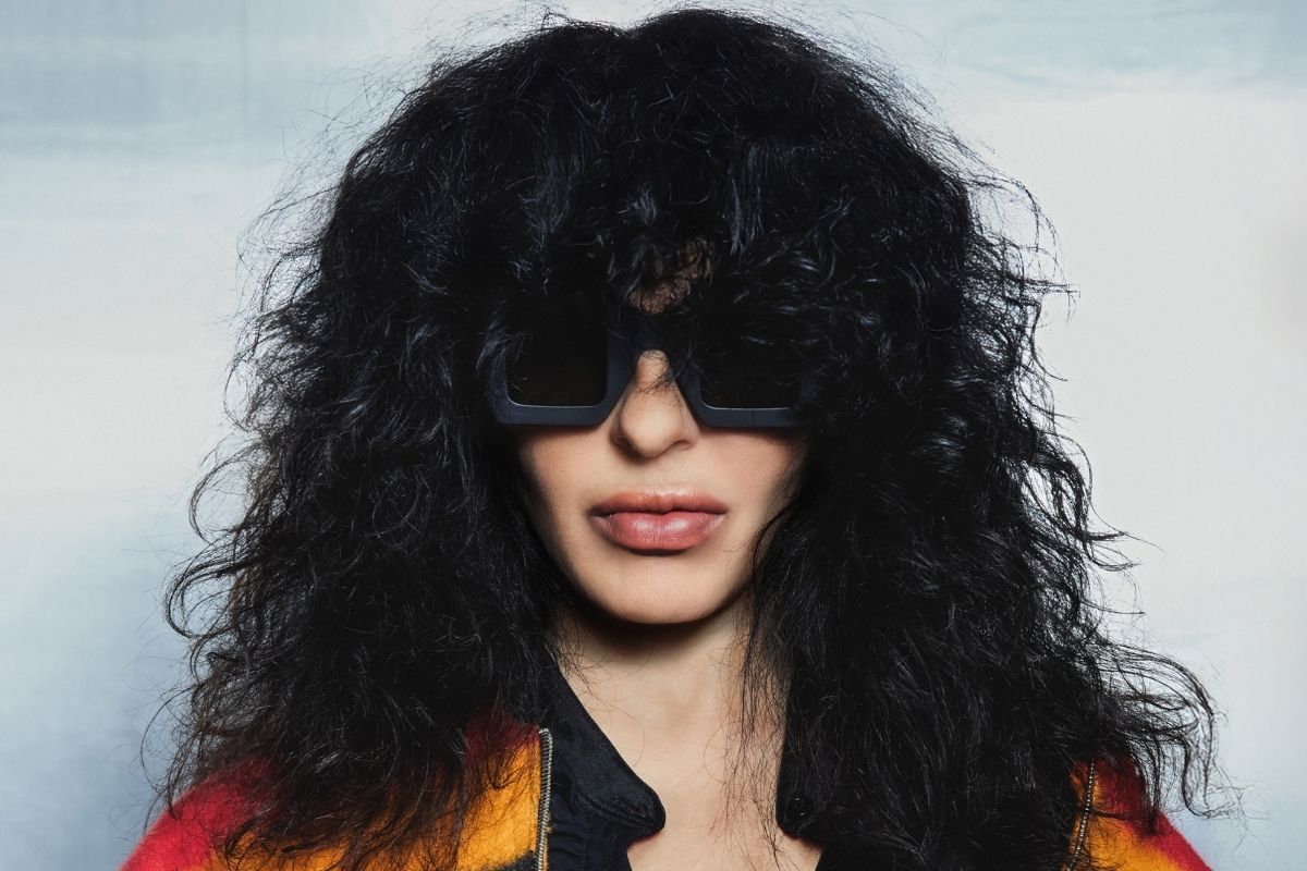 Photo of a woman with black hair wearing glasses.