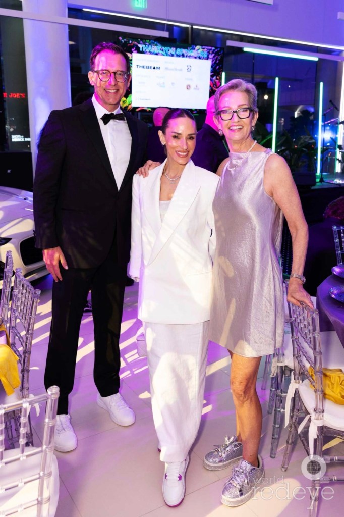 photo of Nikki Spoelstra, Steven Wernick, and Meg Daly posing together in formal outfits at a party