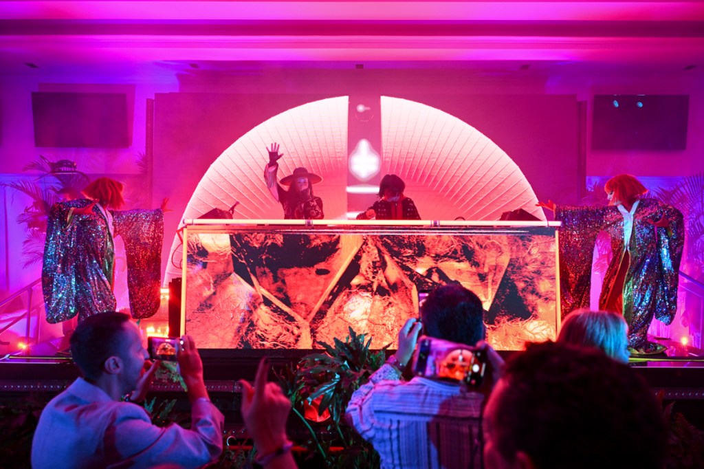 Photo of two DJS performing on stage.
