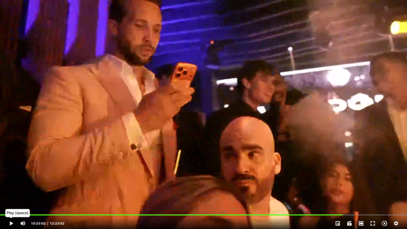 A bald man with a beard is seen on a live stream.