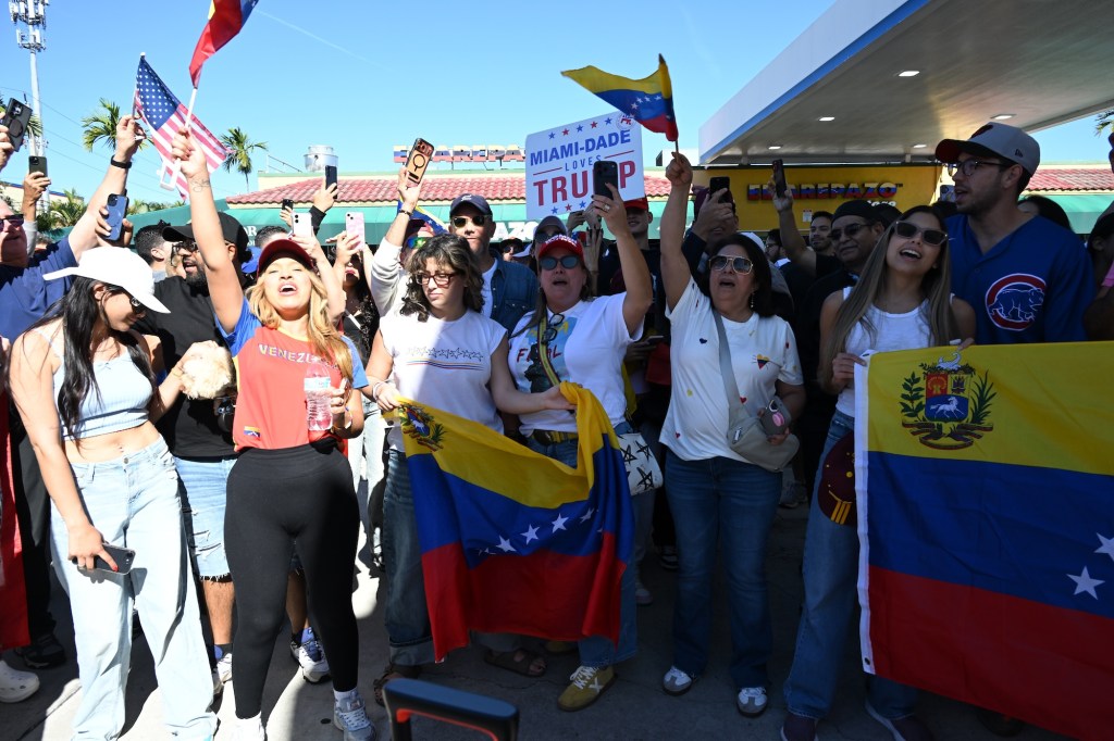 photo of protesters wearing clothes with the Venezuelan flag and waving Venezuelan flags.