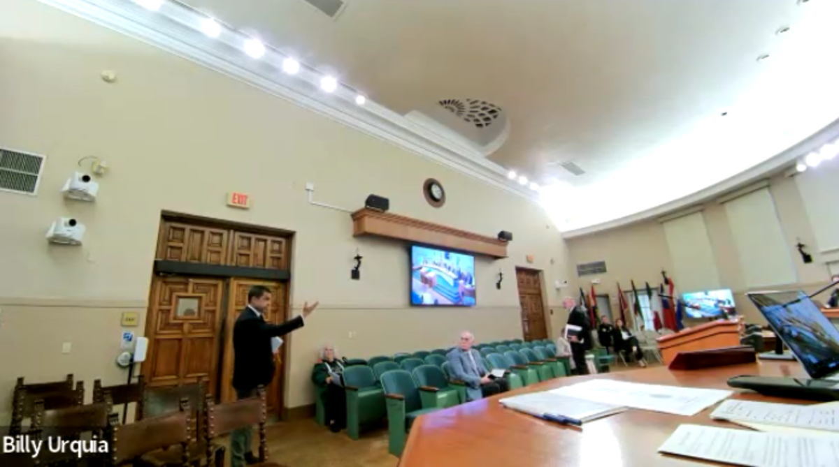 Vince Lago pointing towards the commission as he stands by the door to exit the commission chambers.