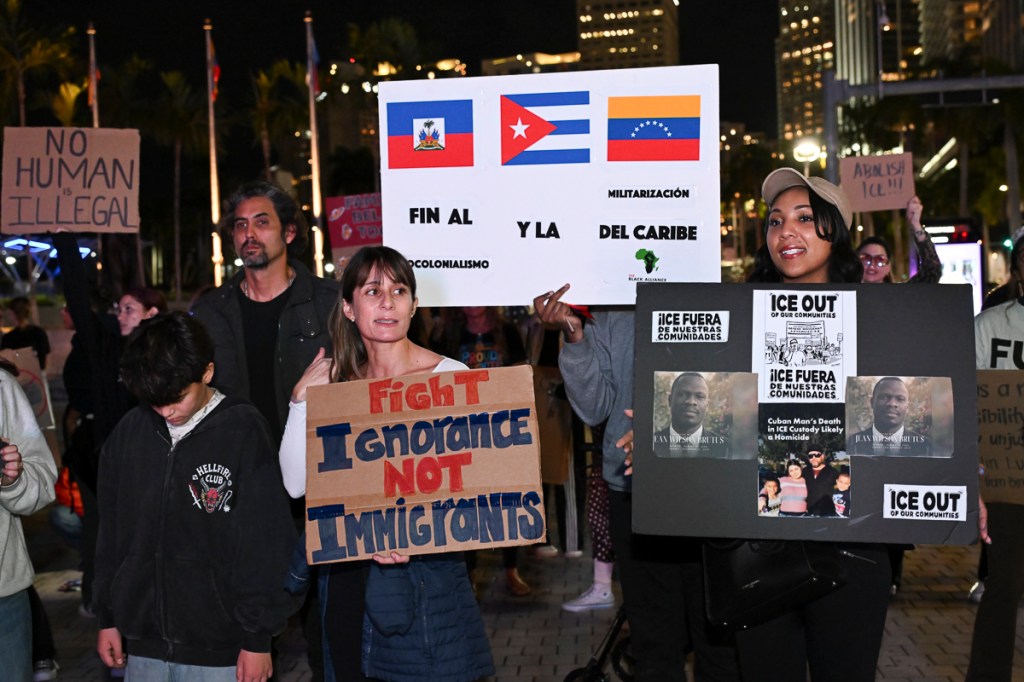 photo of a crowd of protesters holding signs