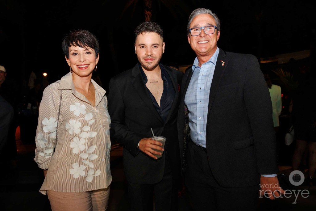 three people — Belkys Nerey, Chef Chris Valdes, and Senator Rene Garcia — posing together at a party