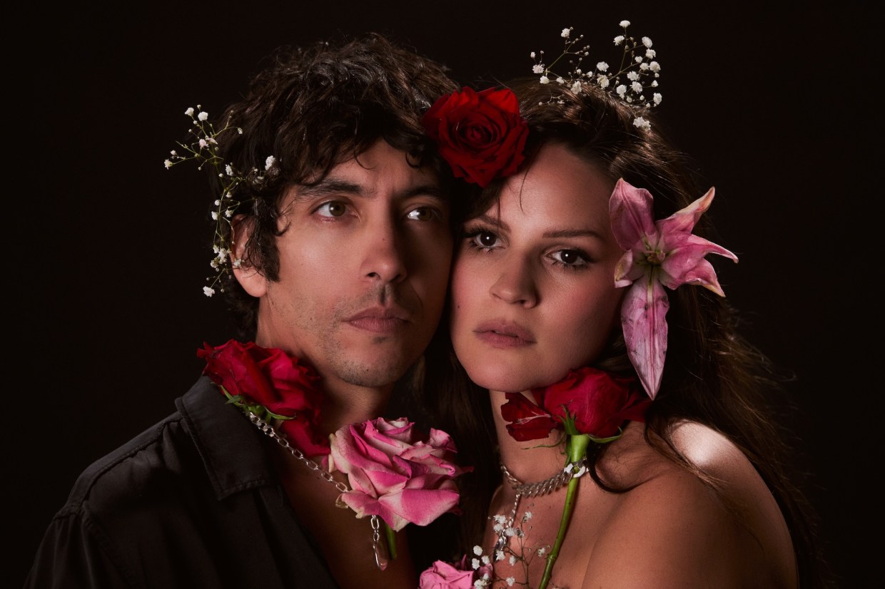 Photo of a couple wearing real flowers