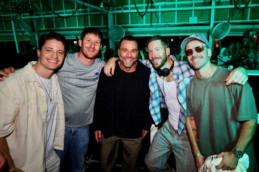 photo of five men — Kygo, Myles Shear, David Grutman, Calvin Harris, and Jon George of Rufus Du Sol — posing together under green lighting in a club