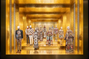 photo of outfits on mannequins inside a room with gold walls and flooring