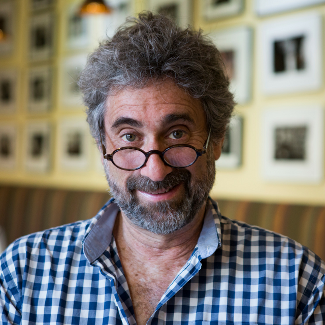 photo of a man with glasses and gray hair in a checkered blue and white button-down shirt